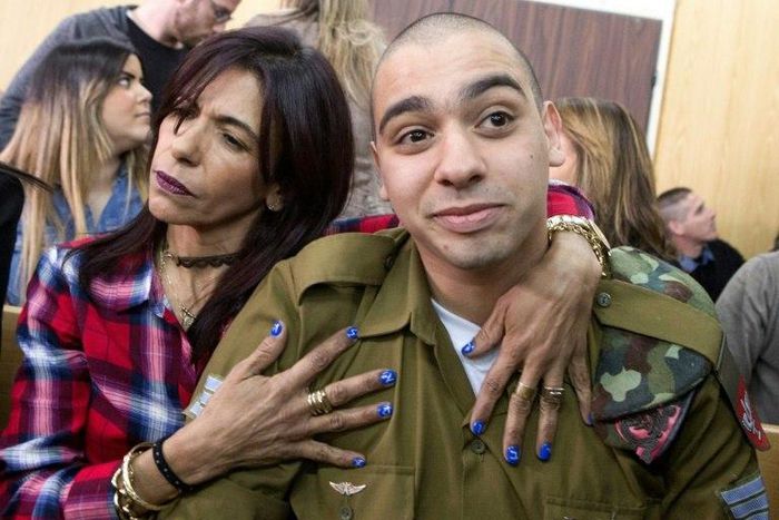 Israeli soldier Elor Azaria is embraced by his mother at the start of his sentencing hearing in a military court in Tel Aviv, on February 21, 2017