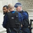 Firearms officers from the British police detain a man on Whitehall near the Houses of Parliament in central London on April 27, 2017