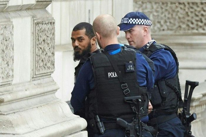 Firearms officers from the British police detain a man on Whitehall near the Houses of Parliament in central London on April 27, 2017