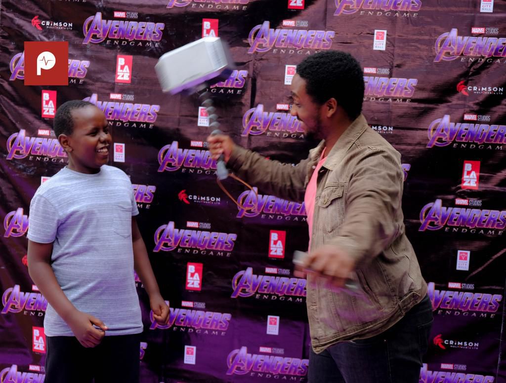 Nick with his small brother wielding Thor's hammer (2)