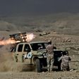 Members of the Iraqi army's 9th Division fire a multiple rocket launcher from a hill in Talul al-Atshana, on the southwestern outskirts of Mosul, on February 27, 2017, during an offensive to retake the city from Islamic State (IS) group fighters