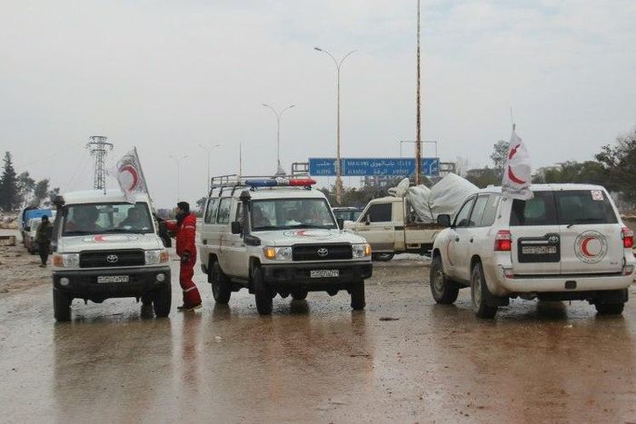 Staff of the Syrian Red Crescent wait on a road in December 2016 for evacuees from Fuaa and Kafraya, two Shiite-majority villages in northwestern Syria that are under siege by the Sunni Muslim rebels