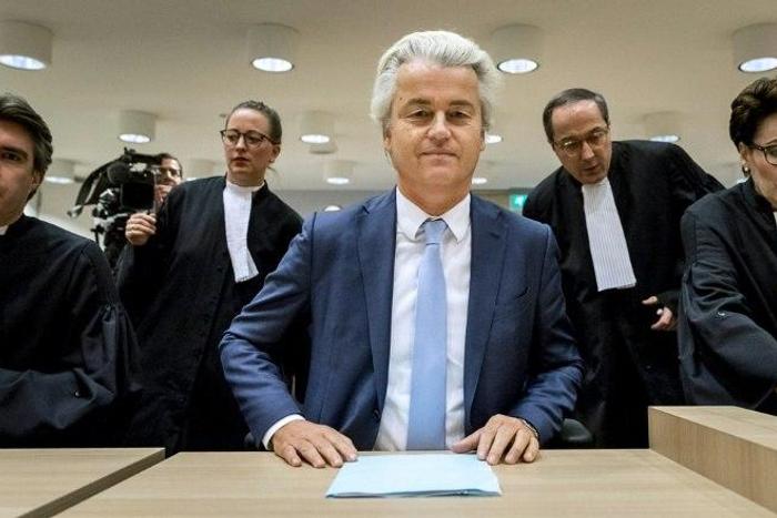 Geert Wilders (C) of the Party for Freedom (PVV) awaits a verdict on charges of insulting a racial group and inciting racial hatred
