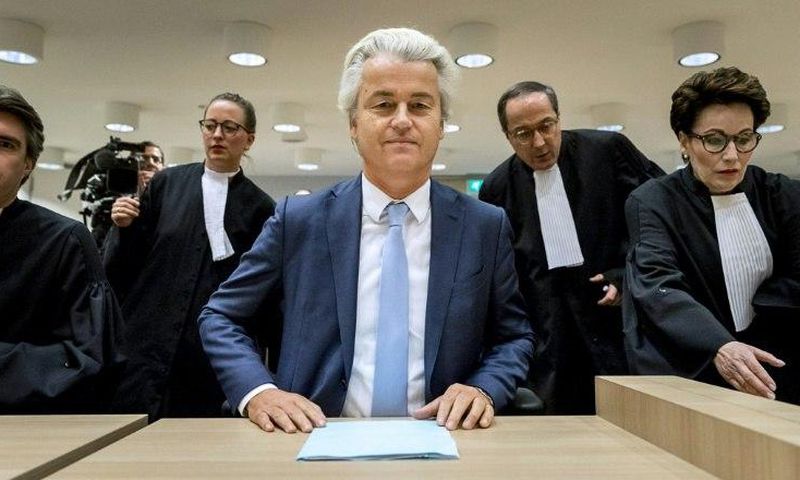 Geert Wilders (C) of the Party for Freedom (PVV) awaits a verdict on charges of insulting a racial group and inciting racial hatred