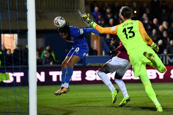 Head for success: Toby Sibbick heads the ball in to score the final goal of Wimbledon's 4-2 win over West Ham in the fourth round of the FA Cup on Saturday