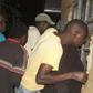 Residents of Nakuru Town West peep through the window of a house where a woman was killed by her lover.