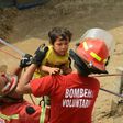 Residents of the Huachipa populous district, east of Lima, are helped on March 17, 2017, by police and firemen rescue teams to cross over flash floods hitting their neighbourhood and isolating its residents