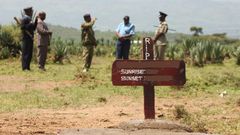 Kenyan police near a grave