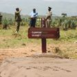 Kenyan police near a grave