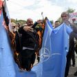 Protesters burn the NATO flag on April 28 during a demonstration against Montenegro's accession to the Western military bloc