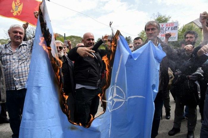 Protesters burn the NATO flag on April 28 during a demonstration against Montenegro's accession to the Western military bloc