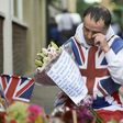 A man lays flowers at a makeshift memorial near Borough Market in London