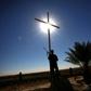 A member of the Iraqi Christian forces Kataeb Babylon (Babylon Brigades) stands guard beneath a cross at the Mar Behnam Syriac Catholic monastery in Khidr Ilyas