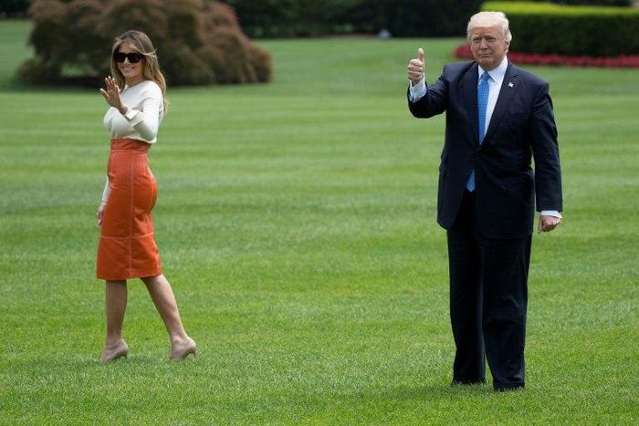 US President Donald Trump (R) gives a thumbs up as he and First Lady Melania Trump (L) depart the White House on this first foreign trip