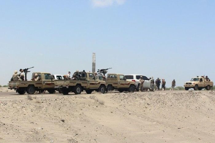 Forces loyal to the Saudi-backed Yemeni president stand guard on a road at the entrance to Abyan province in April 2016