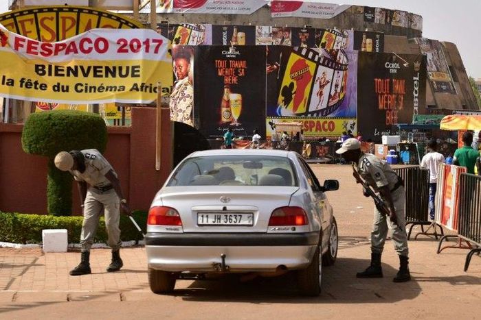 Police officers check cars at the entrance to the Pan-African Film and Television Festival (FESPACO) in Ouagadougou