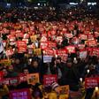 Protesters hold candles and banners calling for the resignation of South Korea's President Park Geun-Hye during an anti-government rally in central Seoul on November 19, 2016