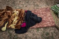 An injured woman waiting for a bus to a holding camp in territory controlled by Syrian Kurds.CreditIvor Prickett for The New York Times