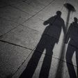 A shadow of two men holding hands (Unspalsh)