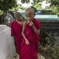 Cemetery personnel bury the body of a three-year-old child, one of three victims of an exorcism ritual in Twante, south of Yangon on October 22, 2016, as young novice monks looks on