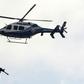A police helicopter flies over a member of security forces near a courthouse in Mugla, western Turkey, on February 20, 2017