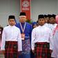 Malaysian Prime Minister Najib Razak (C) inspects a ceremonial guard of honour during the annual congress of his ruling party, the United Malays National Organisation (UMNO)