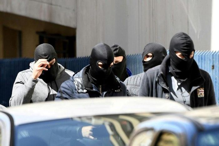 Police found guns, explosives and an IS flag at the suspects' flat