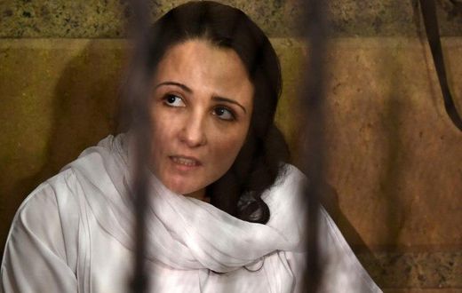 US-Egyptian charity worker Aya Hejazi looks on the from the defendent's cage during her trial in Cairo on April 16, 2017