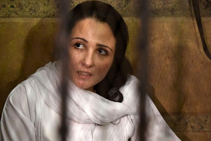 US-Egyptian charity worker Aya Hejazi looks on the from the defendent's cage during her trial in Cairo on April 16, 2017