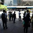 Office workers stand on the grounds of an office building in the financial district of Makati in Manila on April 8, 2017, after a 5.7 magnitude earthquake struck
