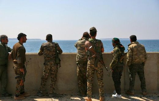 Members of the US-backed Syrian Democratic Forces stand on the Tabqa dam partially recaptured during their drive on the Islamic State group's stronghold in nearby Raqa