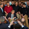 Surrounded by miners from Rosebud Mining, US President Donald Trump (C) signs the Energy Independence Executive Order at the Environmental Protection Agency (EPA) Headquarters in Washington, DC, on March 28, 2017