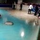 People skate on an ice rink with 5,000 frozen dead fish inside at the Space World amusement park in Kitakyushu, southwestern Japan