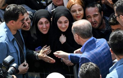 President Recep Tayyip Erdogan greets supporters as Turks vote on whether to grant him extended powers