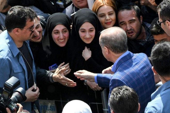 President Recep Tayyip Erdogan greets supporters as Turks vote on whether to grant him extended powers