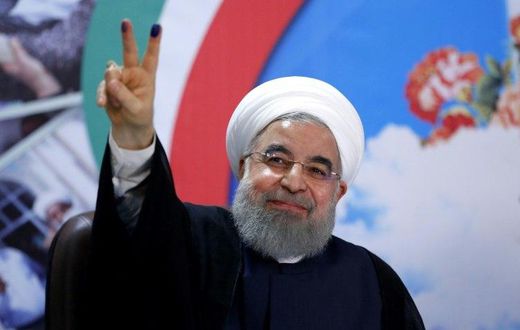 Iranian President Hassan Rouhani gestures to the camera after registering to run for re-election at the interior ministry in Tehran on April 14, 2017