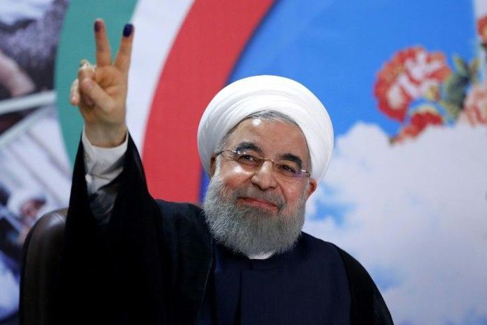 Iranian President Hassan Rouhani gestures to the camera after registering to run for re-election at the interior ministry in Tehran on April 14, 2017