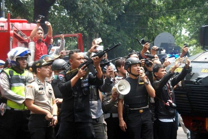 Indonesian police call out to an attacker to surrender during a firefight at a government office in Bandung, February 27, 2017