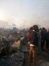 Locals look on as fire spreads at the Toi Market on Tuesday March 12, 2019 (Oliver Oketch)
