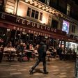 People sit on the terrace of the Cafe Republique near the Place de la Republique in Paris