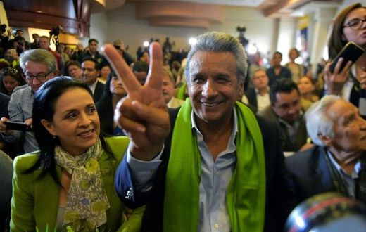The Ecuadorean presidential candidate of the ruling Alianza PAIS party, Lenin Moreno, next to his wife Rocio Gonzalez (L), listens to the first results of the runoff election, in Quito on April 2, 2017