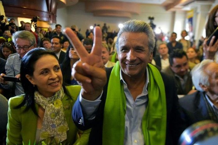 The Ecuadorean presidential candidate of the ruling Alianza PAIS party, Lenin Moreno, next to his wife Rocio Gonzalez (L), listens to the first results of the runoff election, in Quito on April 2, 2017