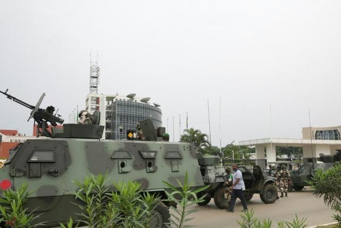 Soldiers guard the headquarters of Gabon's state radio and television after the foiled coup