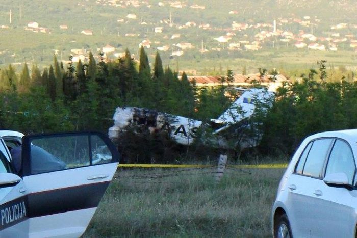 Bosnian police and Civil Aviation Investigators are seen near the site where a light planed crashed near Mostar, Bosnia and Herzegovina, on May 13, 2017