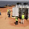 Technicians operate electrical cabinets on October 22, 2016 during the opening ceremony of a new photovoltaic energy production site in Bokhol