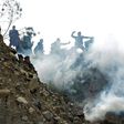 Bolivian coca growers from Los Yungas region confront riot police agents within a tear gas cloud, during a protest against a bill that caps legal coca crops extensions in La Paz on February 21, 2017