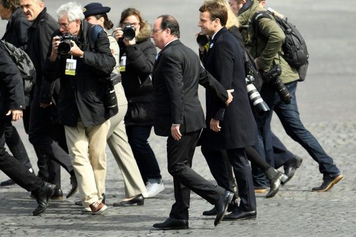 French President Francois Hollande walks with president-elect Emmanuel Macron at a ceremony marking the 72nd anniversary of the victory over Nazi Germany during World War II