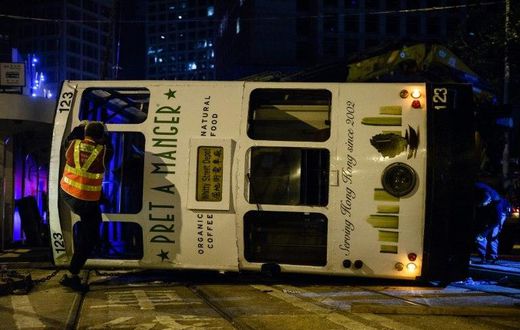 Five women and nine men were injured when a Hong Kong tram flipped over in the city's financial district in the early hours of Thursday