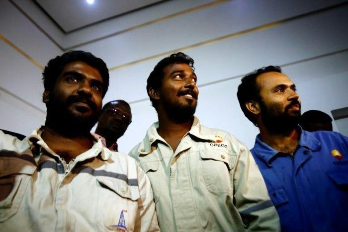 (L to R) Indians Midhun Ganesh and Edward Ambrose and Pakistani Ayaz Hussein Jamali, look on upon their arrival at Khartoum airport on March 30, 2017