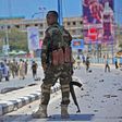 Somali security forces guard the site of a suicide blast in Mogadishu in August 2016